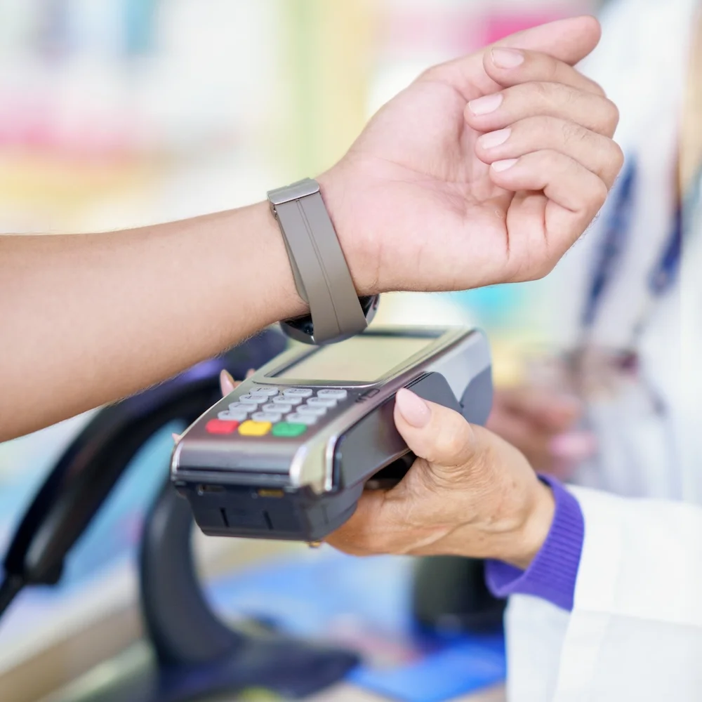 man-paying-by-smartwatch-in-dr-office